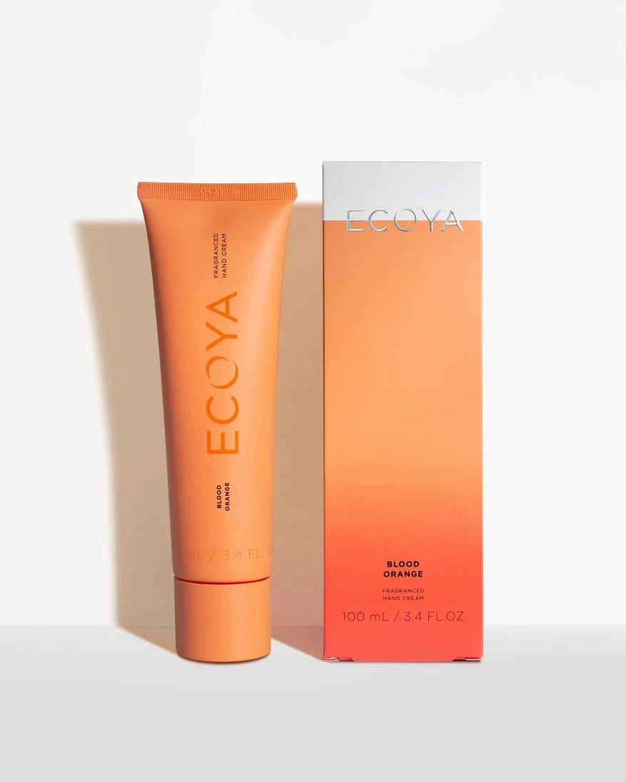 ECOYA Blood Orange 100ml Hand Cream positioned next to it's packaging in stunning orange sunset colours.